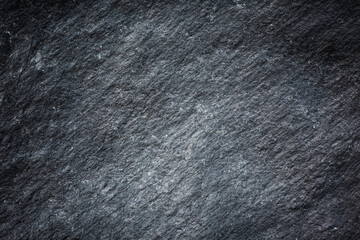Wall Mural - Patterned structure of black slate background texture for design.