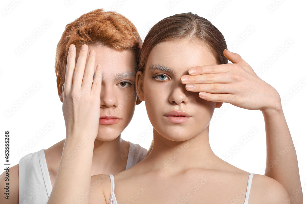 Teenagers with dyed eyebrows on white background