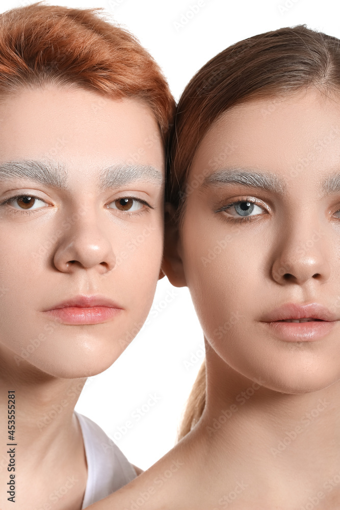 Teenagers with dyed eyebrows on white background, closeup