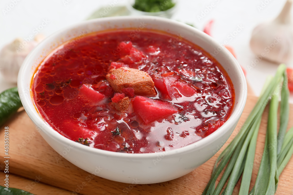 Bowl with tasty borscht on table, closeup