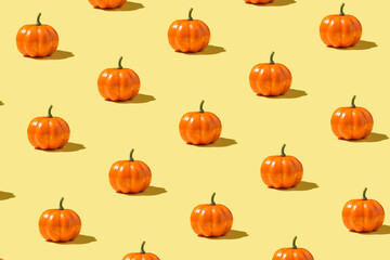 Wall Mural - Photo of orange pumpkins on isolated yellow background