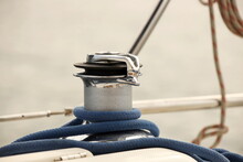 A Winch On A Sailing Yacht For Pulling Up Files And Sheets Against The Background Of The Summer Sea. Outfit Of A Sailing Yacht. Facilitating Human Labor On Board. Mar Practice In A Yachting School.