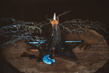 Candle burns on the altar, magic among candles, clean energy, magical concept, autumn time	