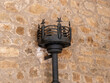 Closeup shot of a black wrought iron cresset torch on a wall