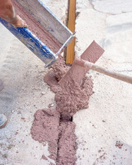 Filling with colored concrete of excavation with a narrow section for the implementation of a fiber optic distribution network for telecommunications.