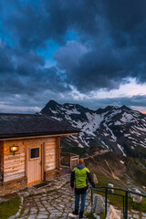 Poster - Active Man Walking Into Chalet on High Alpine Mountains and Sunset
