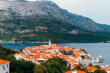 Wall Mural - Old town of Korcula on the background of the mountains of Peljesac peninsula, Adriatic sea, Croatia