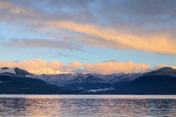 Wall Mural - Sunrise in the Pacific Northwest over the Olympic Mountains with fresh snow in the hills and early morning light