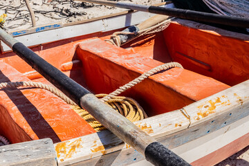 traditional fishing net on small rowing boat on beach
