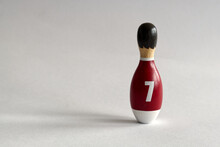 Rearview Of A Wooden Puppet In The Shape Of A Bowling Pin With A Number Seven Shirt