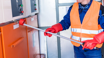Wall Mural - the engineer checks the absence of induced voltage on the high voltage cells