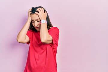 Poster - Middle age hispanic woman wearing casual clothes suffering from headache desperate and stressed because pain and migraine. hands on head.