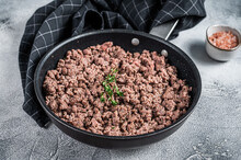 Fried Ground Mince Beef And Pork Meat In A Pan With Herbs. White Background. Top View