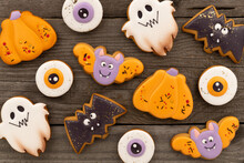 Delicious Halloween Homemade Cookies Of Various Shapes On Old Wooden Table