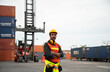© tool51 - Portrait of Foreman smiling while standing in container yard for check cargo transportation import - export. Logistic concept.