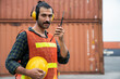 © tool51 - Engineer  use walkie-talkie in order to control container from Cargo freight for import and export. Safety hard hat prevent accident and various equipment in industry..