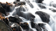 White Rushing Water Flowing Over Exposed Jagged Rocks