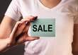 © valiantsin - Sale word on paper in female hands.