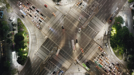 Wall Mural - Beautiful aerial view to a crossroad in Seoul Gangnam District on the evening. Cars, buses and other vehicles turning at the busy intersection surrounded by modern skyscrapers.