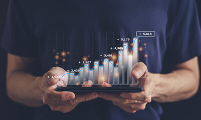 Hand holding growth investment chart or business financial graph.