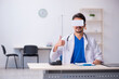 © Elnur - Young male doctor wearing virtual glasses in the clinic