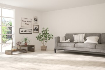 White living room with sofa and summer landscape in window. Scandinavian interior design. 3D illustration