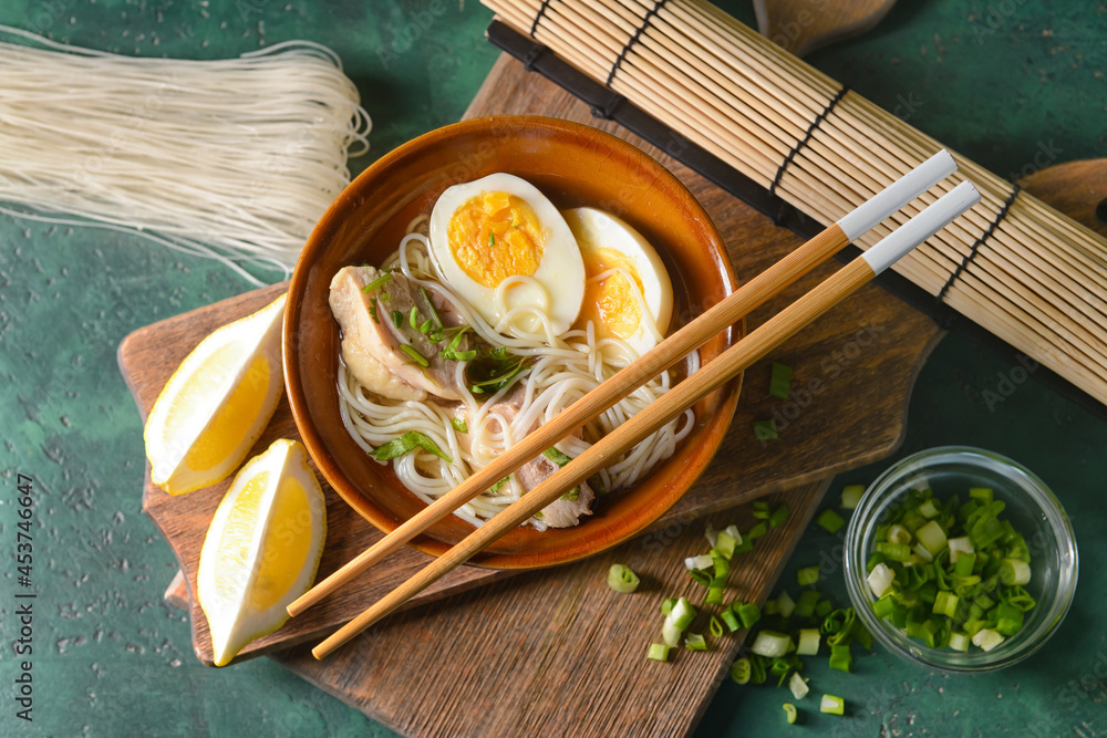 Composition with tasty Chinese soup on color background
