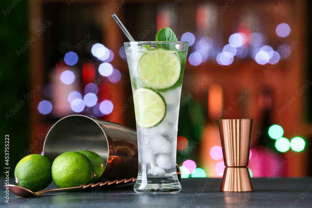 Glass of fresh mojito on table in bar