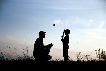 Canvas Print - silhouette of father and son playing baseball on nature family sport