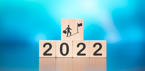 Canvas Print - Wooden cube with concept of business target in 2022 on blue background