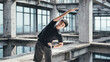 © Anciens - Young Asian man is doing body stretching in an abandoned reinforced concrete building