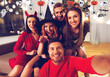 © Syda Productions - friendship, holiday and people concept - group of happy smiling friends in halloween costumes of vampire, devil, witch and cheetah taking selfie at home party at night