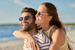 © Syda Productions - leisure, relationships and people concept - happy couple in sunglasses hugging on summer beach