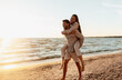 © Syda Productions - leisure and people concept - happy couple having fun on summer beach