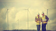 Two engineers work on renewable wind farms. sustainable energy industry