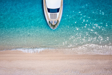 Wall Mural - aerial top down view of a luxury yacht moored at a paradise beach with turquoise sea and no people f