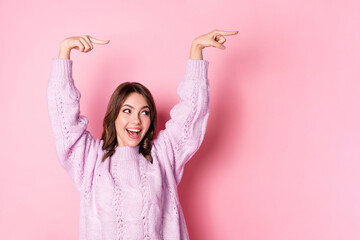 Poster - Portrait of attractive cheerful girl demonstrating copy space ad isolated over pink pastel blue color background