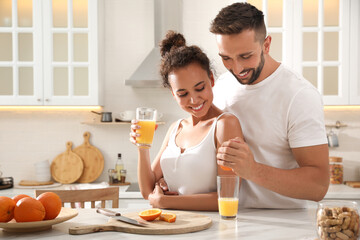 Canvas Print - Lovely couple enjoying time together during breakfast at table in kitchen