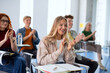 © Halfpoint - Portrait of group of university students sitting in classroom indoors, studying.