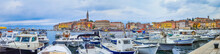 Rovinj port with clouds and boats