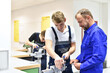 © industrieblick - Group of young people in technical vocational training with teacher
