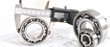 Quality control in modern mechanical engineering - caliper gauges, technical drawing and ball bearings on white background