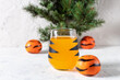 © dashtik - orange mandarin cocktail in glass with black stripes. Christmas holiday welcome drink. Concept for children new year