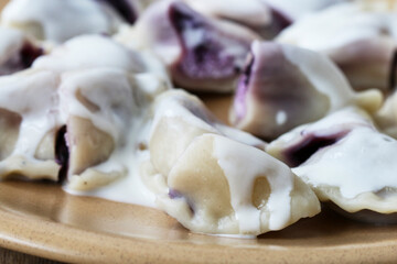 Wall Mural - Sweet dumplings with purple fruits and cottage cheese.