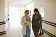 © KOTO - Doctor and businesswoman walking in hospital corridor