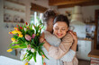 © Halfpoint - Happy senior mother hugging adult daughter indoors at home, mothers day or birthday celebration.
