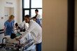© KOTO - Doctors rushing patient on gurney in hospital corridor