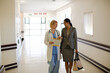 © KOTO - Doctor and businesswoman walking in hospital corridor
