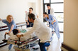 © KOTO - Doctors rushing patient on gurney in hospital corridor
