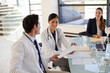 © KOTO - Doctors and businesswoman talking in meeting